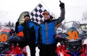 Mike Morgan and Chris Olds celebrating victory next to their wrapped sleds