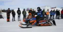 An Arctic Cat Ascender at the SAE Clean Snowmobile Challenge that is wrapped with the Keith Curtis Mountain King Signature design