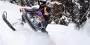 Chris Burandt riding a Polaris Axys snowmobile wrapped with his custom design