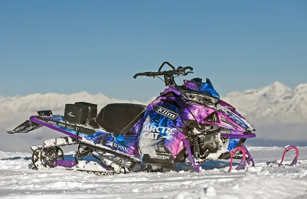 A Arctic Cat Ascender snowmobile with a black, purple, and blue galaxy Cosmic Camo custom vinyl wrap.