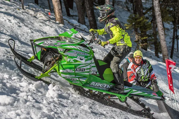 A Arctic Cat Proclimb snowmobile with a green, white and gray stripes Burandt Evolution custom vinyl wrap.