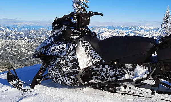 A Arctic Cat Proclimb snowmobile with a gray and black grunge pattern Cataclysm custom vinyl wrap.
