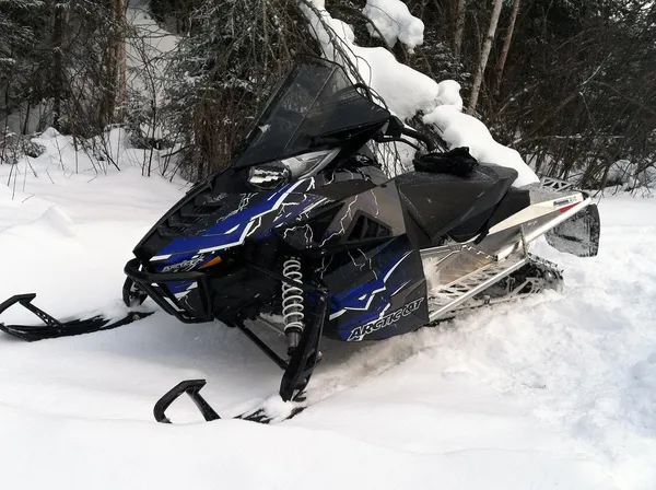 A Arctic Cat Procross snowmobile with a blue, white and black lightning Shock Treatment custom vinyl wrap.