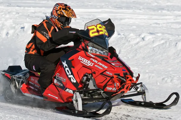 A Polaris Axys Trail snowmobile with a black and red racing stripes Relay custom vinyl wrap.