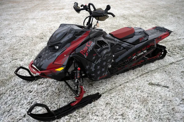 A Ski-Doo Gen5 Mountain snowmobile with a black, red, and gray RayC's American Flag custom vinyl wrap.