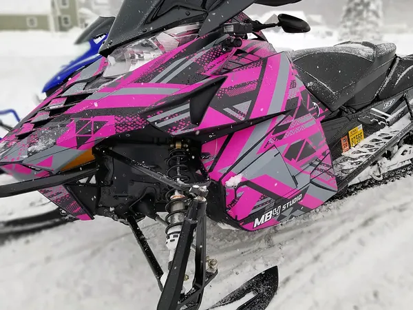 A Yamaha Viper snowmobile with a black, gray, and pink MB4 Trifecta custom vinyl wrap.